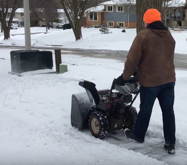 Man using snowblower